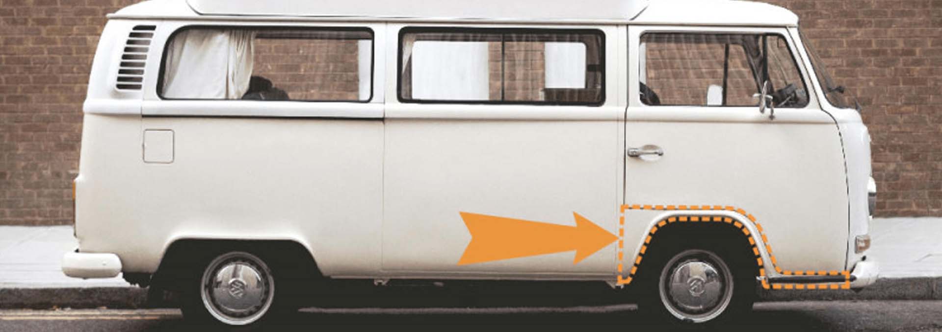 A white VW T2 Bay with the wheel arch highlighted in orange, with an orange arrow pointing to it