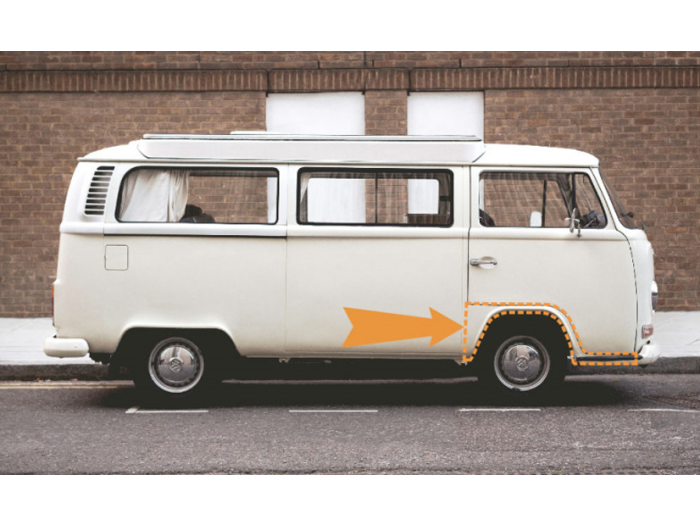 a white VW T2 Bay with the wheel arch highlighted in orange, with an orange arrow pointing to it