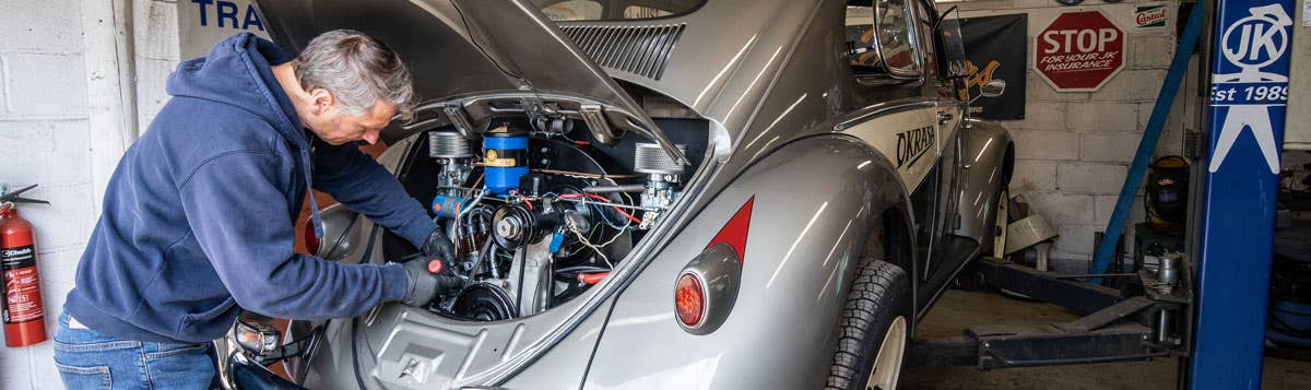 Our resident mechanic "Workshop Mark" servicing a VW Beetle's engine