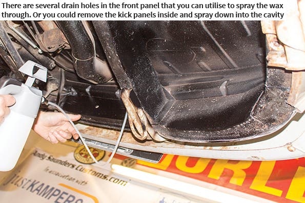 There are several drain holes in the front panel that you can utilise to spray the wax through. Or you could remove the kick panels inside and spray down into the cavity